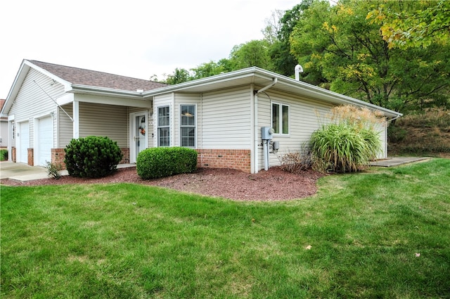 view of side of home with a lawn and a garage