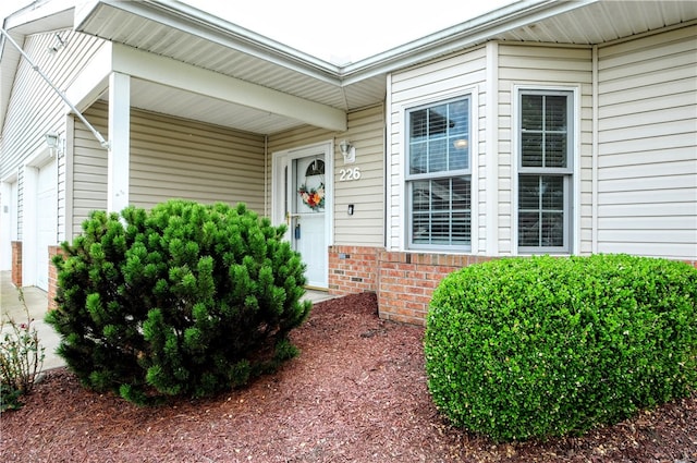 view of exterior entry with a garage