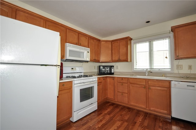 kitchen with white appliances, sink, and dark wood-type flooring