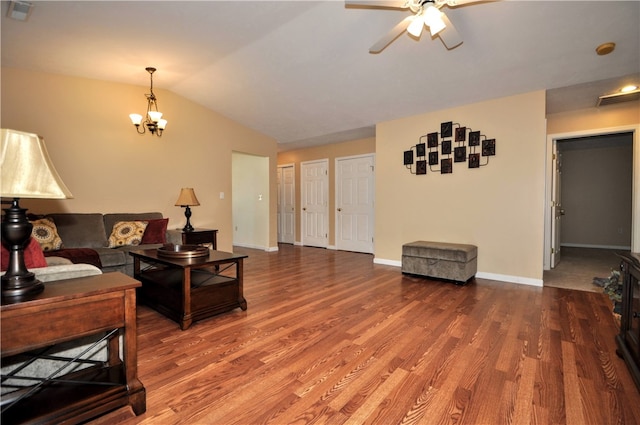 living room with ceiling fan with notable chandelier, wood-type flooring, and lofted ceiling