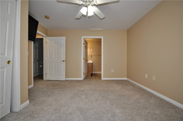 unfurnished bedroom with ceiling fan, light colored carpet, and connected bathroom