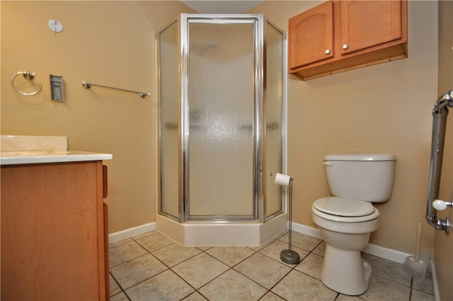 bathroom featuring vanity, tile patterned flooring, an enclosed shower, and toilet