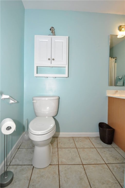 bathroom with tile patterned flooring, vanity, and toilet