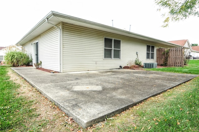 back of house with a patio, central AC unit, and a yard