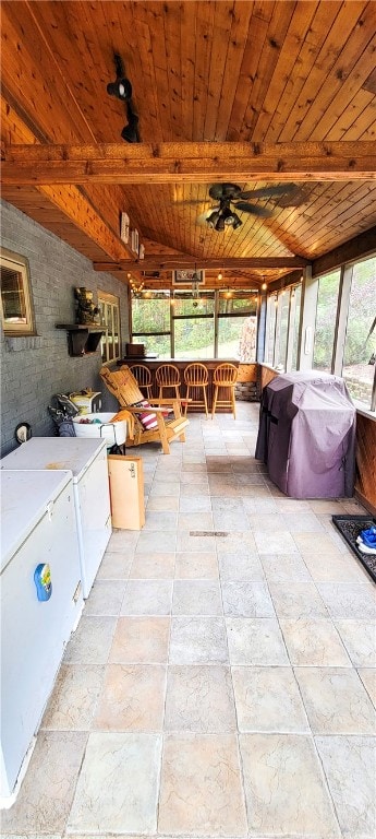 exterior space featuring ceiling fan, grilling area, and washing machine and dryer