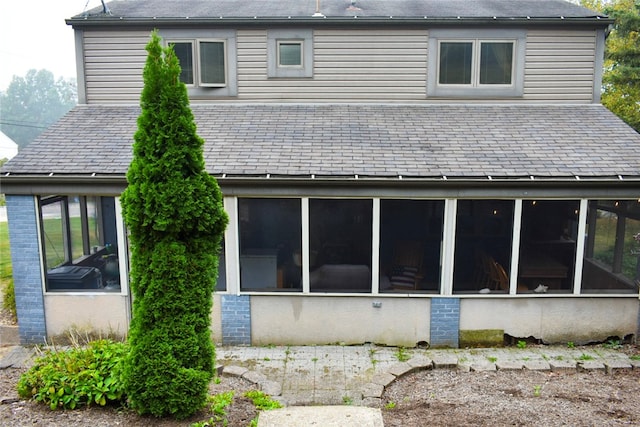 back of property featuring a sunroom