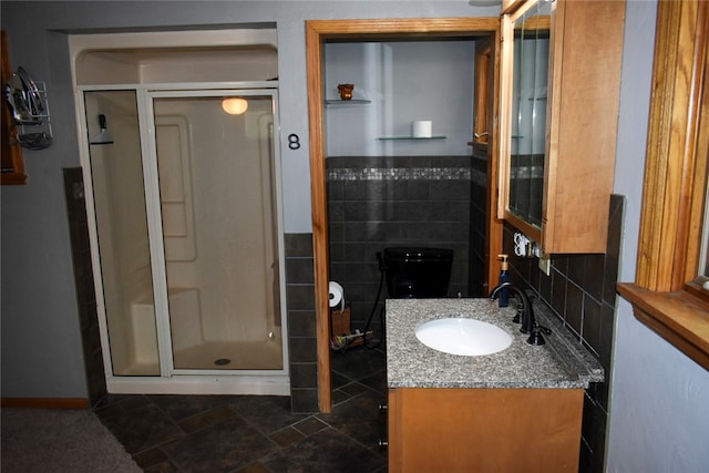 bathroom with walk in shower, vanity, and tasteful backsplash