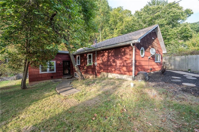 rear view of property featuring a yard