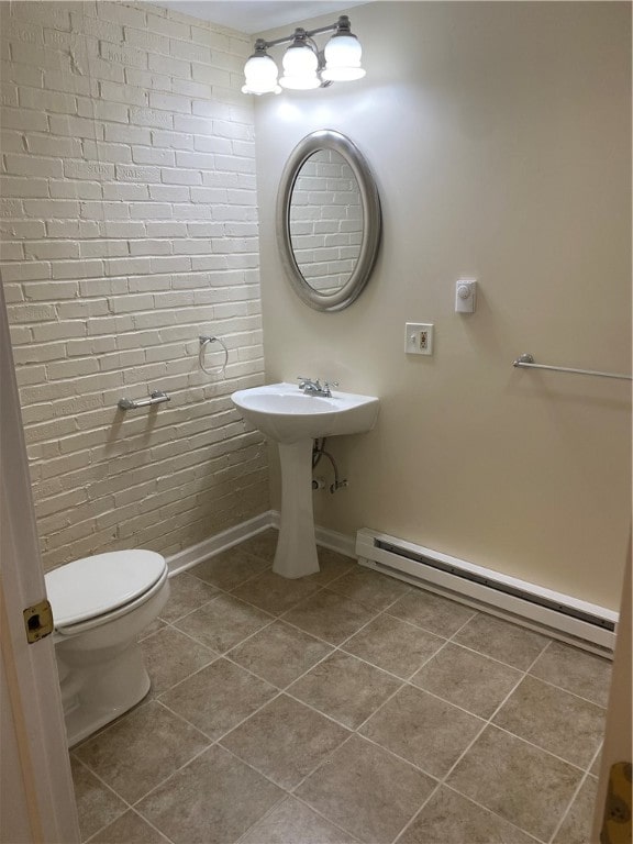 bathroom featuring toilet, baseboard heating, and tile patterned floors