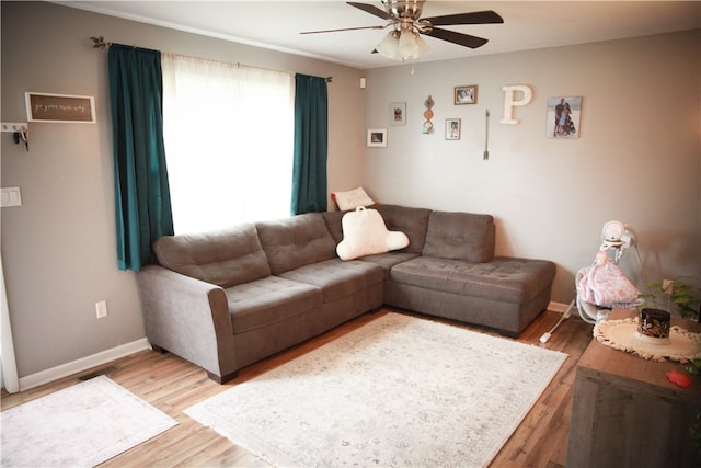 living room featuring hardwood / wood-style floors and ceiling fan