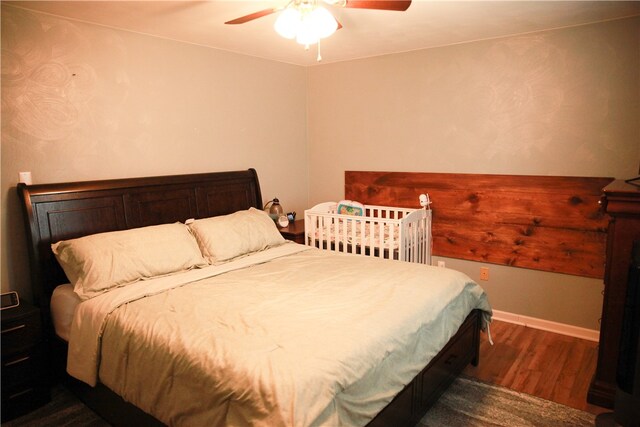 bedroom featuring ceiling fan and dark wood-type flooring