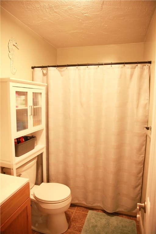 bathroom with a textured ceiling, walk in shower, vanity, and toilet