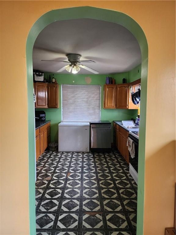 kitchen featuring arched walkways, electric stove, stainless steel dishwasher, and ceiling fan