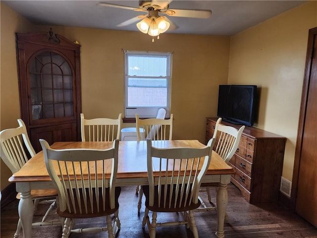 dining space featuring wood finished floors, visible vents, and a ceiling fan