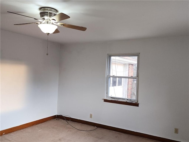 unfurnished room featuring light carpet, ceiling fan, and baseboards