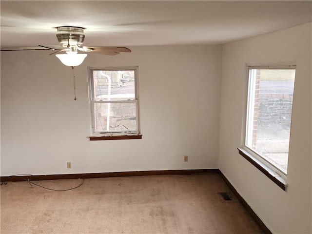 unfurnished room with a ceiling fan, baseboards, visible vents, and carpet flooring