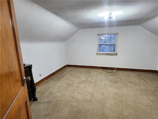 bonus room featuring carpet, lofted ceiling, and baseboards