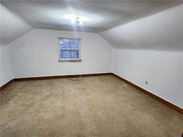 bonus room featuring carpet floors, lofted ceiling, and baseboards