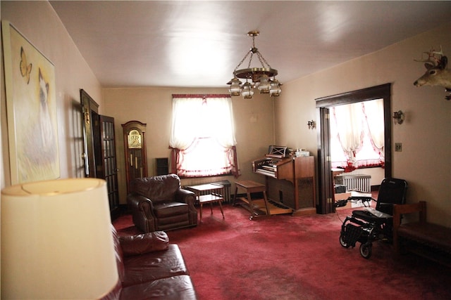 interior space featuring a notable chandelier and radiator heating unit