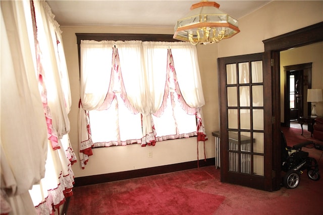 interior space with an inviting chandelier and dark carpet