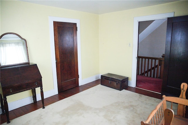 bedroom featuring dark hardwood / wood-style flooring and a closet