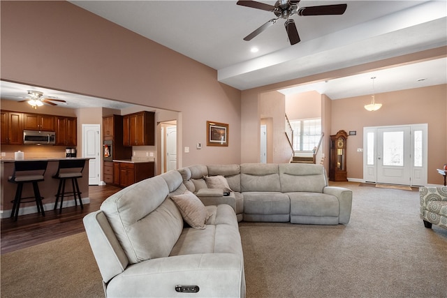 living room with ceiling fan, vaulted ceiling, and dark hardwood / wood-style floors