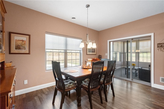 dining room with plenty of natural light and dark hardwood / wood-style flooring