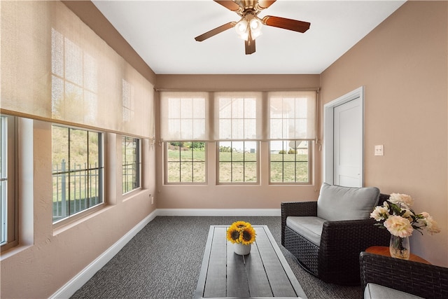 sunroom featuring ceiling fan