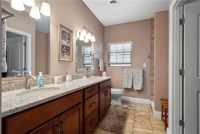 bathroom with tile patterned floors, vanity, and toilet