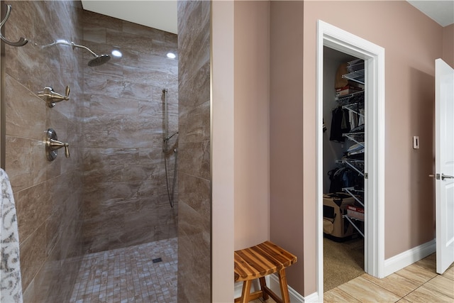 bathroom with tile patterned floors and tiled shower