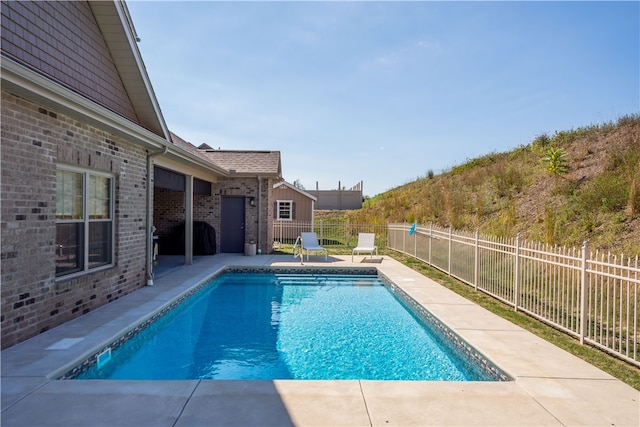 view of swimming pool with a patio