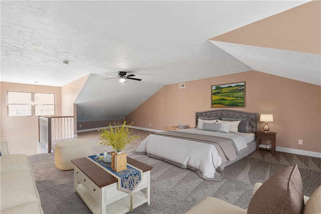 carpeted bedroom with ceiling fan, a textured ceiling, and vaulted ceiling