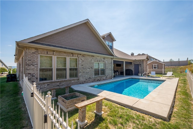 view of pool with a lawn and a patio area