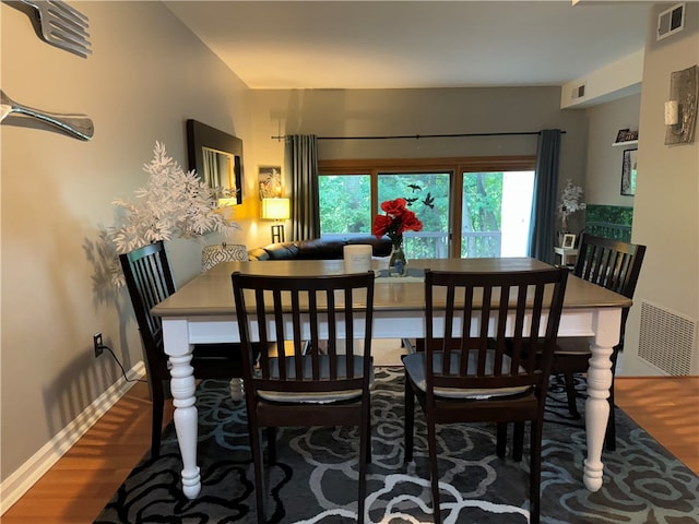 dining space with dark hardwood / wood-style flooring