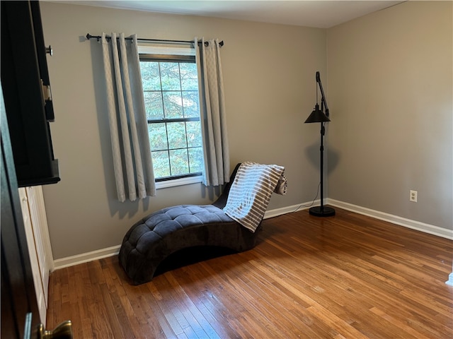 sitting room with hardwood / wood-style flooring