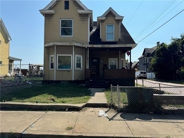 view of front of home featuring a front yard and covered porch