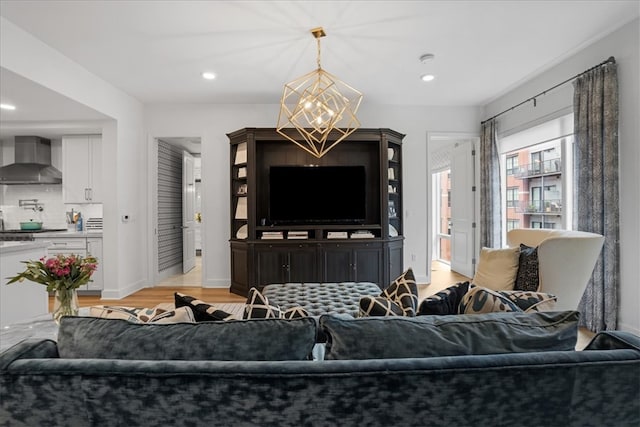 living room with light wood-type flooring and a chandelier