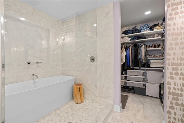 bathroom with tile walls and independent shower and bath