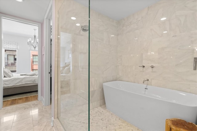 bathroom featuring independent shower and bath, an inviting chandelier, tile walls, and tile patterned floors