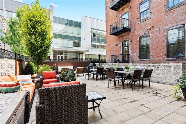 view of patio with an outdoor hangout area and a balcony