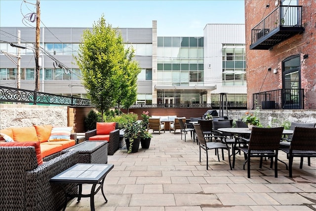 view of patio featuring a balcony and an outdoor living space