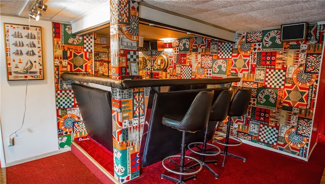 bar with a textured ceiling and carpet floors