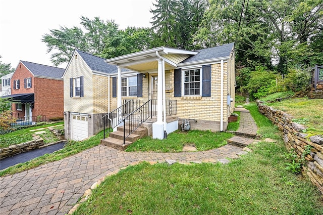 bungalow with a front lawn and a garage