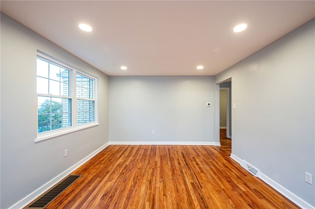 unfurnished room with hardwood / wood-style floors