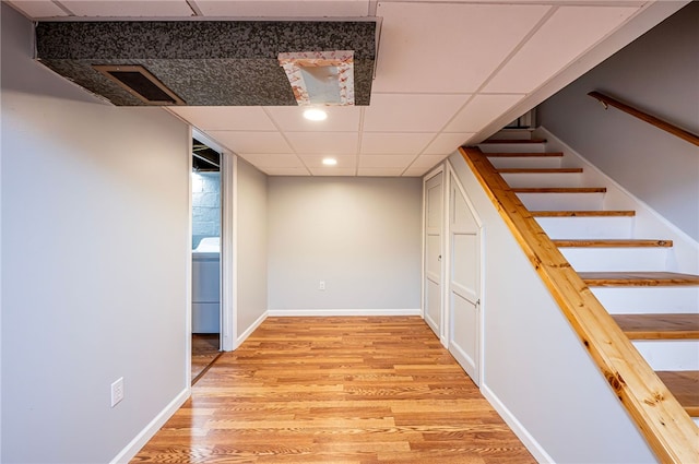 interior space with light wood-type flooring and a paneled ceiling