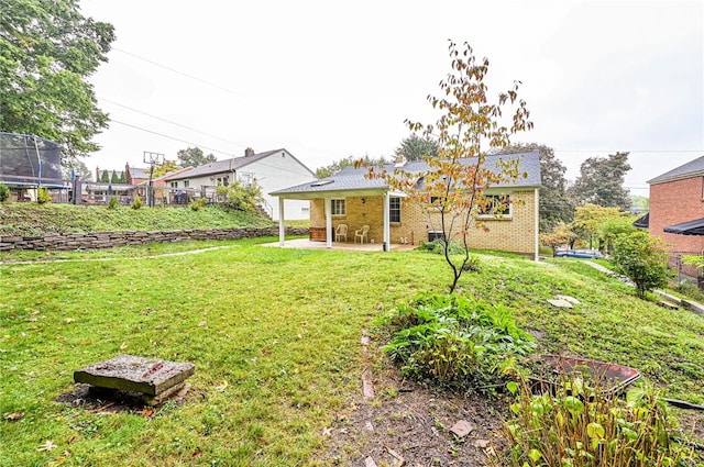 view of yard featuring a patio and a trampoline