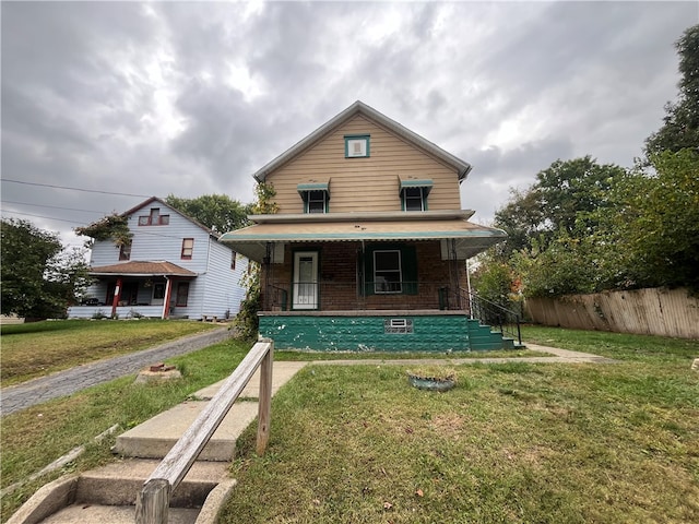 view of front facade with a porch and a front lawn