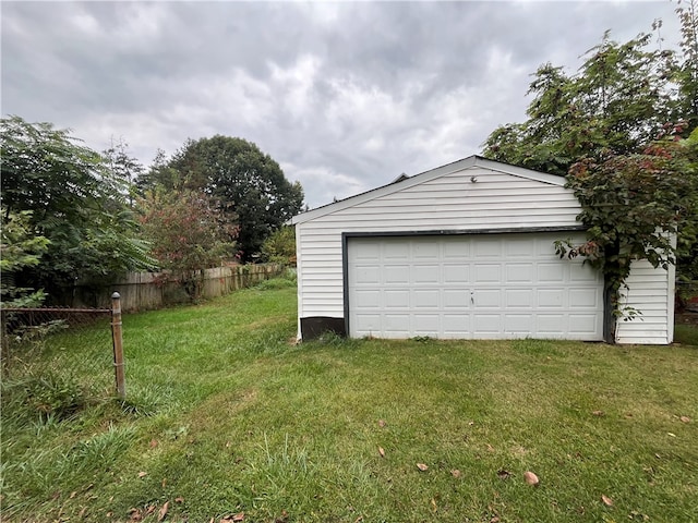 garage featuring a lawn