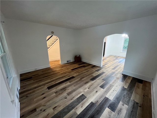 unfurnished room with dark hardwood / wood-style flooring