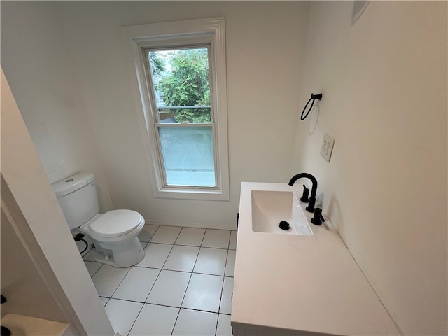 bathroom featuring toilet, tile patterned flooring, and sink